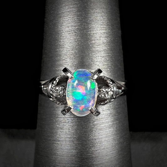 A platinum jelly opal engagement ring set with diamond accents and a rope design.