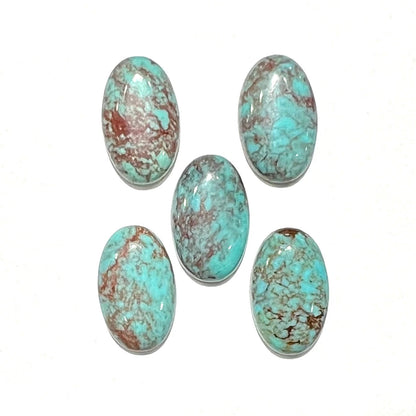 A loose lot of 5 oval cabochon cut Tyrone turquoise stones.  The stones are blue with red webbed matrix.