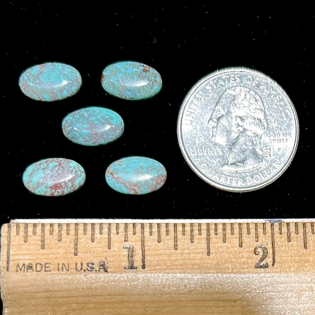 A loose lot of 5 oval cabochon cut Tyrone turquoise stones.  The stones are blue with red webbed matrix.