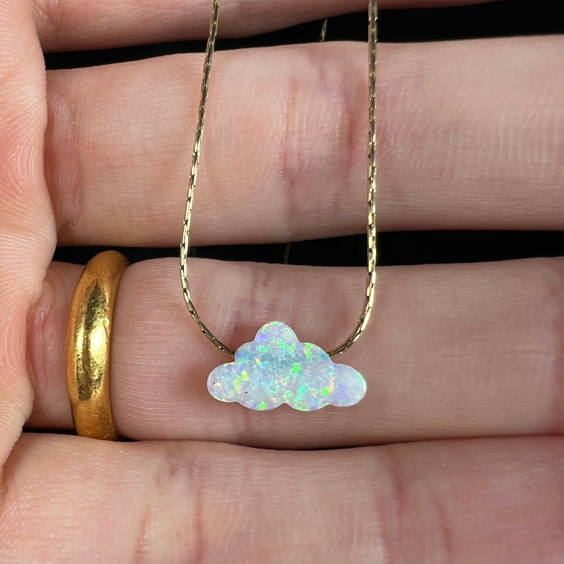 A lab-created opal cloud necklace on a gold filled chain.