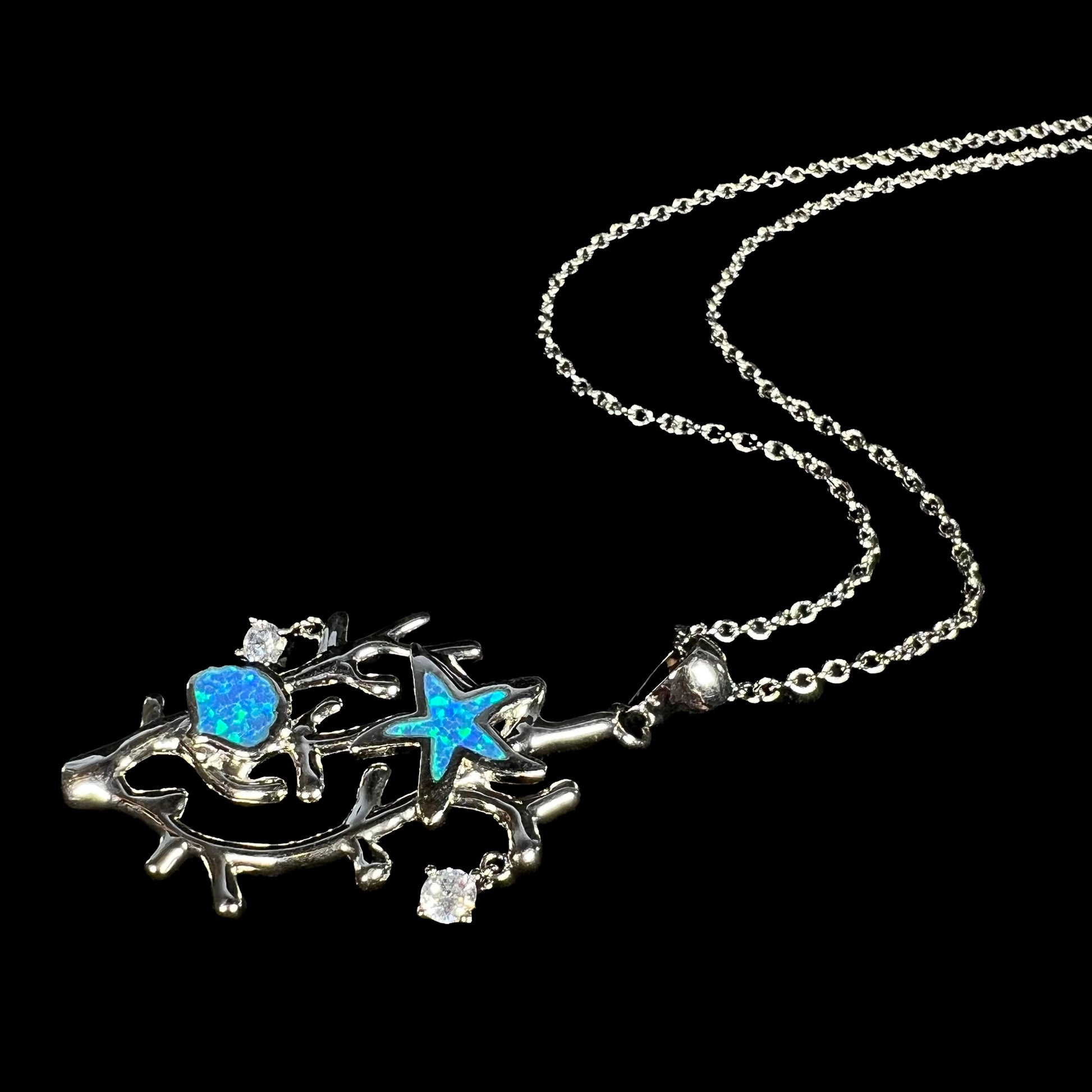 A silver plated coral reef necklace with blue lab-created opal inlay and CZ accents.