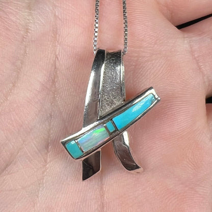 A folded design sterling silver turquoise and lab-created opal inlay necklace.