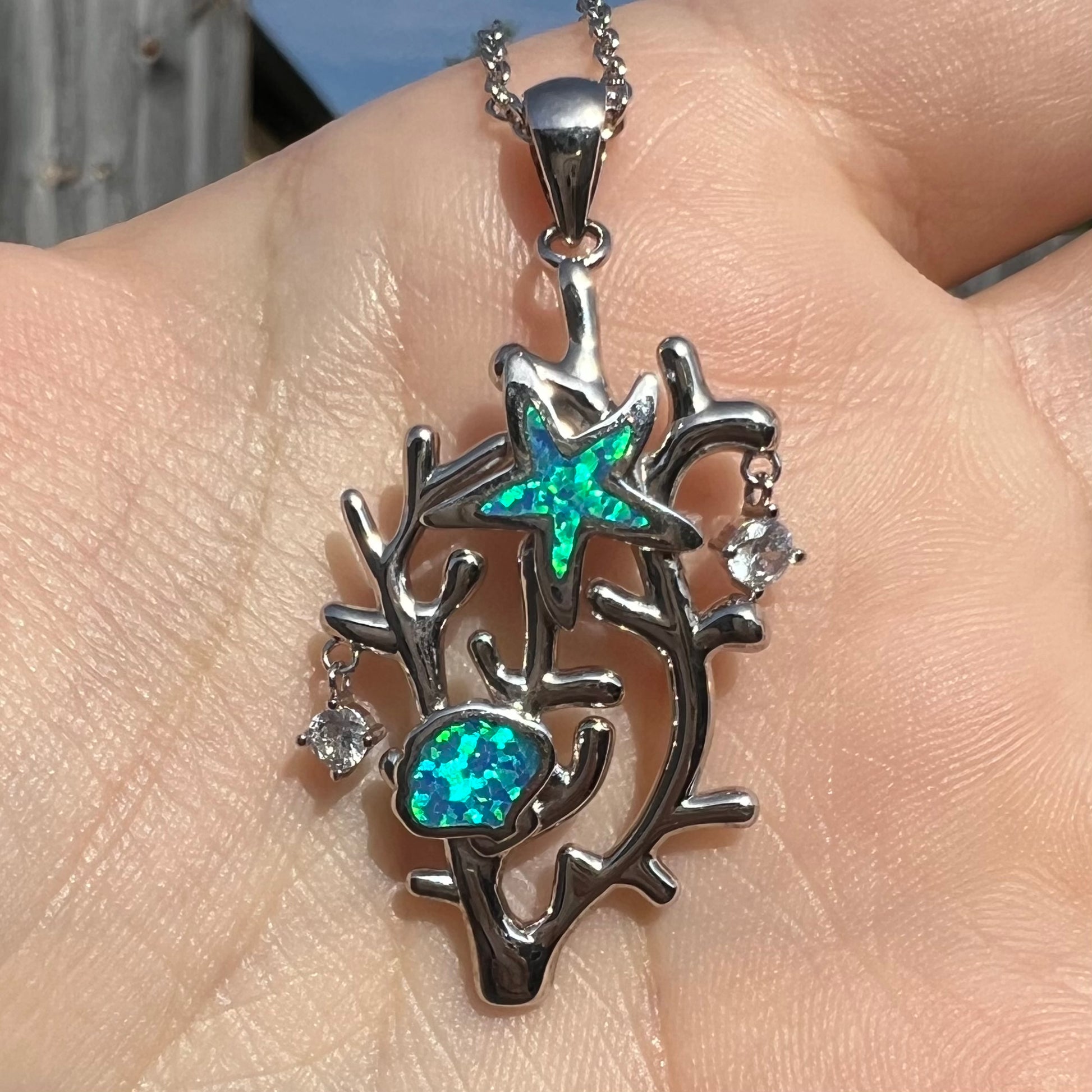 A silver plated coral reef necklace with blue lab-created opal inlay and CZ accents.