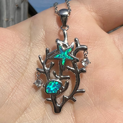 A silver plated coral reef necklace with blue lab-created opal inlay and CZ accents.