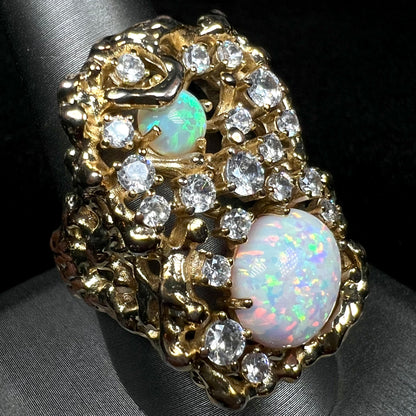 A large ring set with multicolor lab-created opals and CZs, shown close-up from angle on ring display.