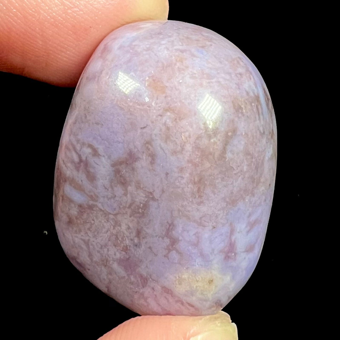 A tumbled Turkish purple jade stone.  The material is a "white" lilac purple color.