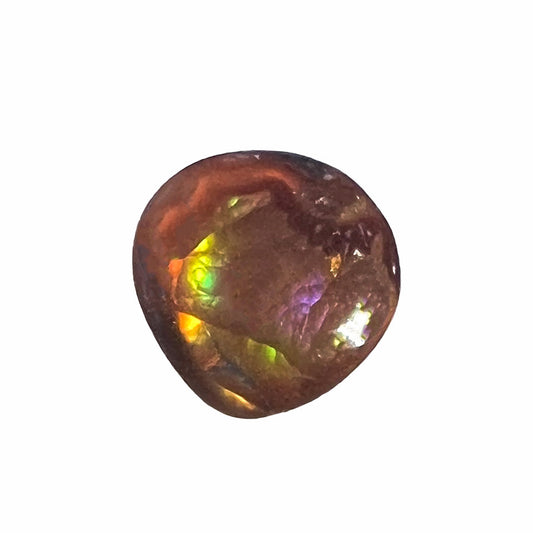 A loose, round cabochon cut Mexican fire agate gemstone.  The stone has a sagenite inclusion.