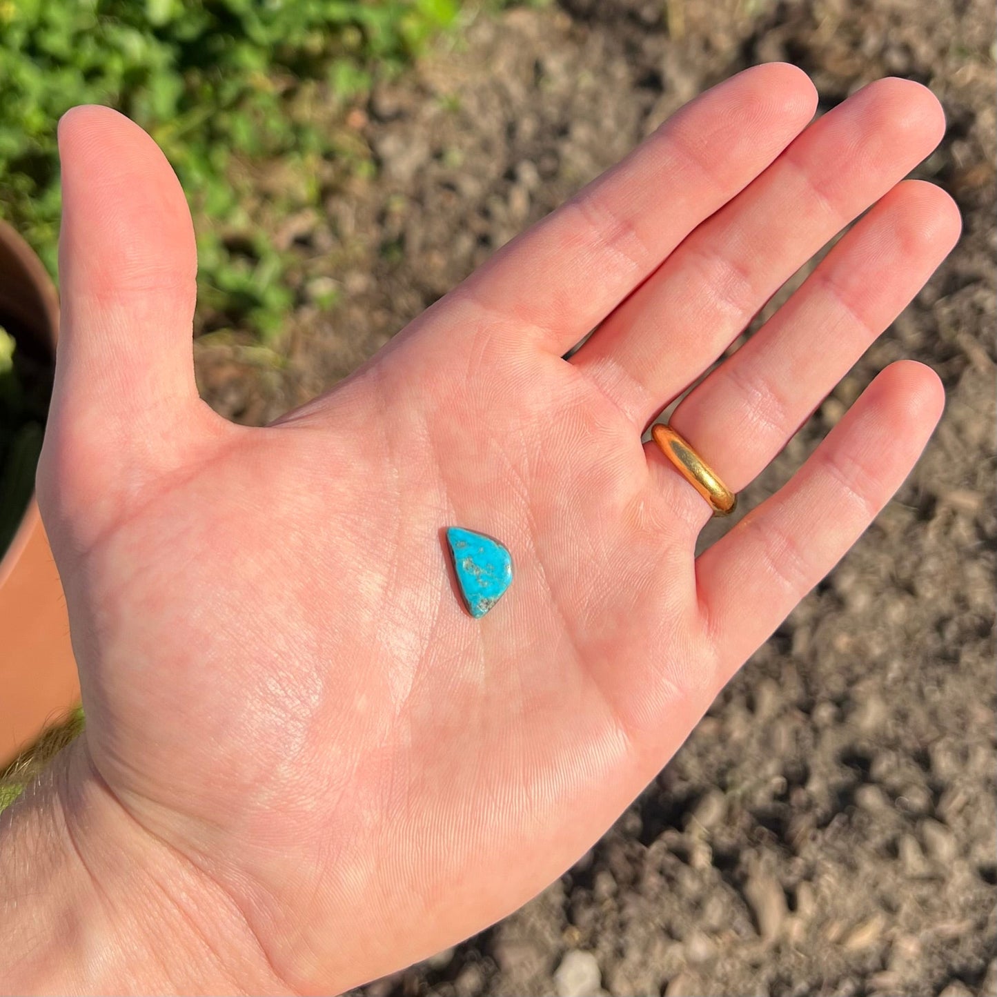 A loose, freeform cabochon cut Kingman turquoise stone.  The stone is bright blue.