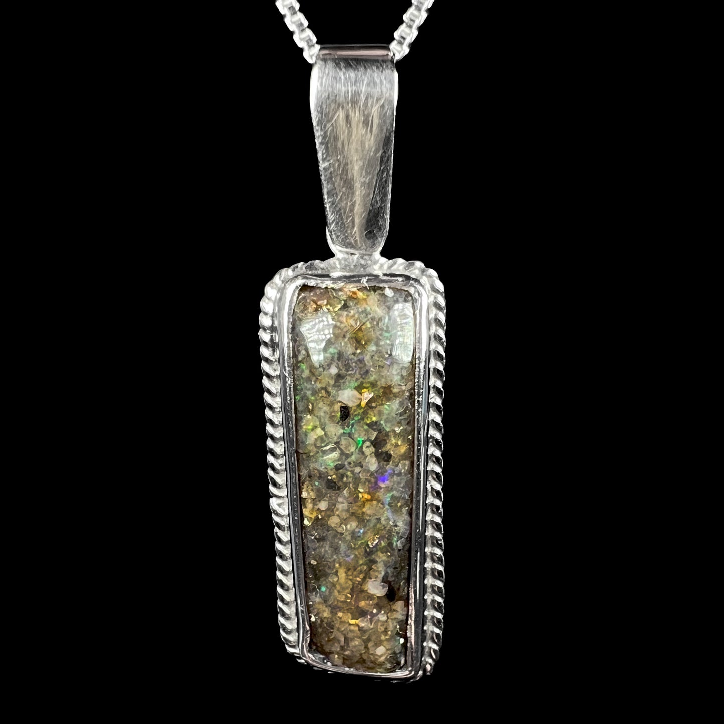 A Louisiana matrix opal pendant in sterling silver, shown close-up from the front against a black background.