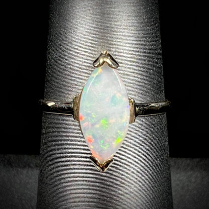 A marquise cut natural opal solitaire ring in yellow gold.