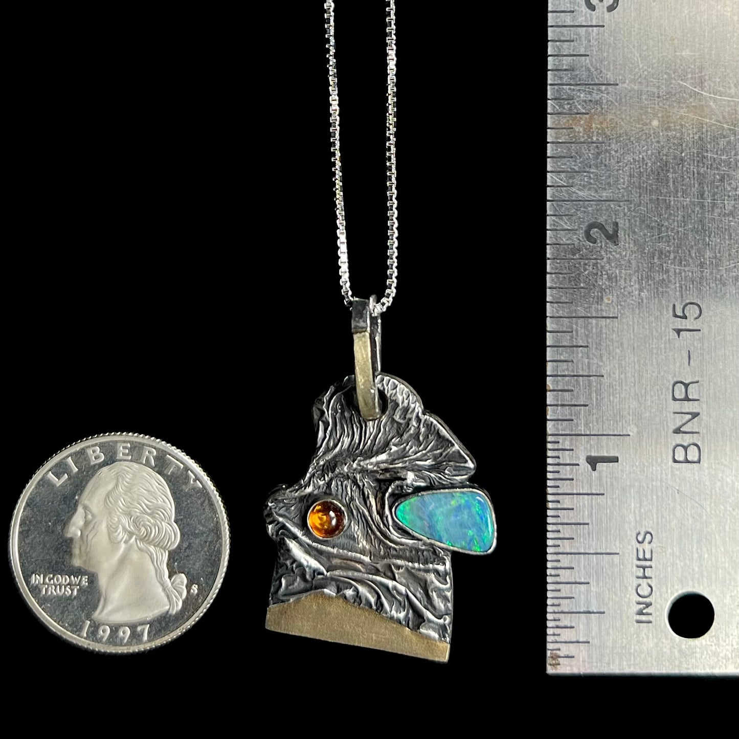 A 1.6 inch-long men's Australian opal doublet and amber pendant, shown next to a ruler and US quarter coin for scale.