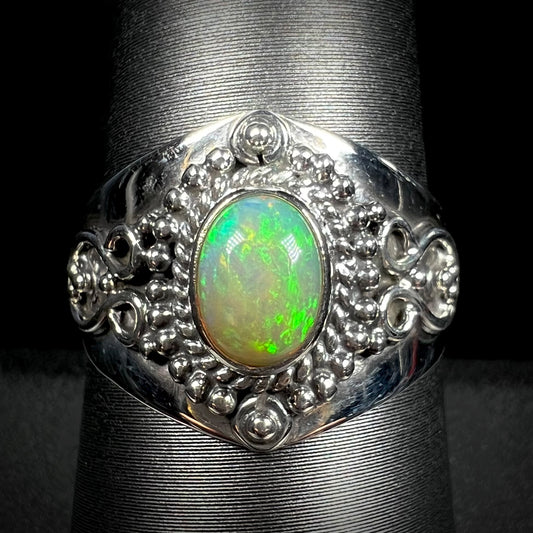 A men's sterling silver, boho style Ethiopian fire opal solitaire ring, shown from the front.