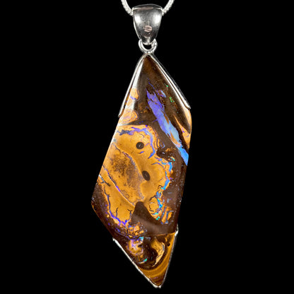 Men's brown freeform shaped Australian boulder opal pendant in sterling silver shown close-up
