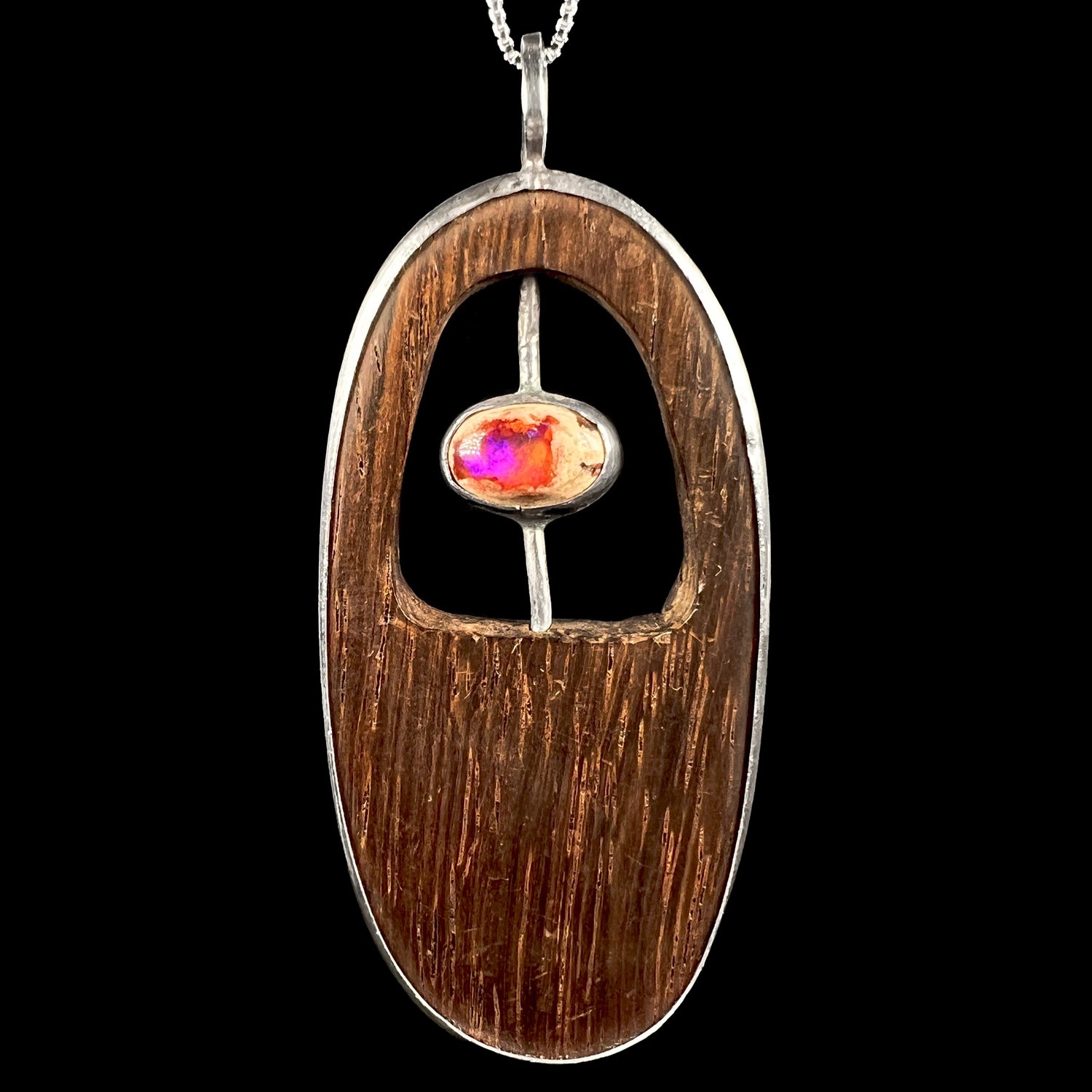 A rustic-style men's Mexican cantera opal and wood pendant in a handmade sterling silver bezel, shown close-up from the front.