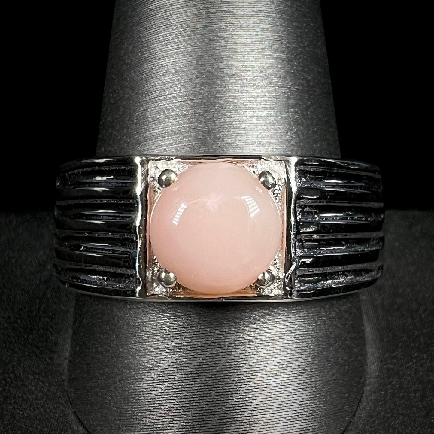Front view of men's sterling silver pink Peruvian opal ring on ring display