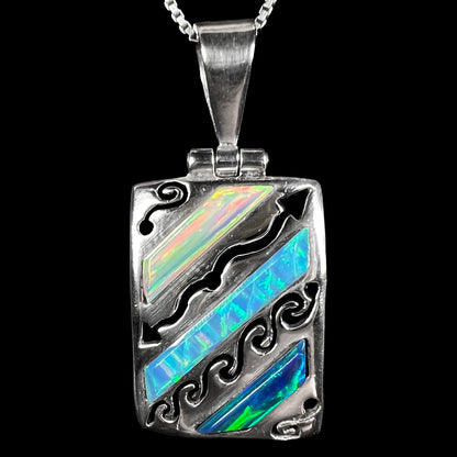 A men's Southwest-style 950 silver lab-created opal pendant, shown close-up against a black background.