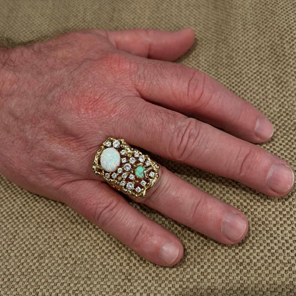 Man's hand wearing size 11 lab-created opal and CZ costume ring with large bird's nest design.