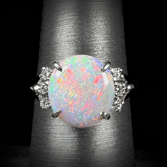 A 1.10ct Mintabie opal engagement ring set in platinum with three diamond accents on each side of the opal.