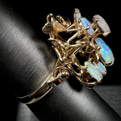 A ladies' vintage, modernist style opal cluster ring in yellow gold.  The ring is tall with a high profile.