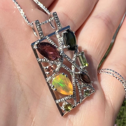 A sterling silver multi-gemstone necklace set with Ethiopian opal, tourmaline, and diamonds.