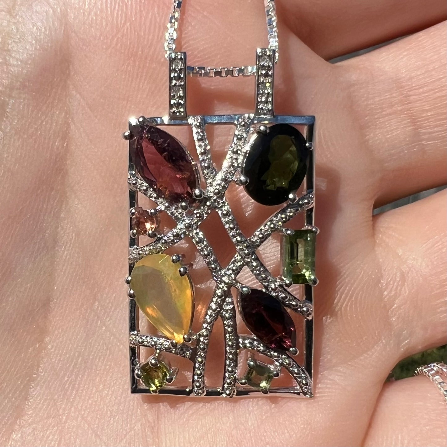 A sterling silver multi-gemstone necklace set with Ethiopian opal, tourmaline, and diamonds.