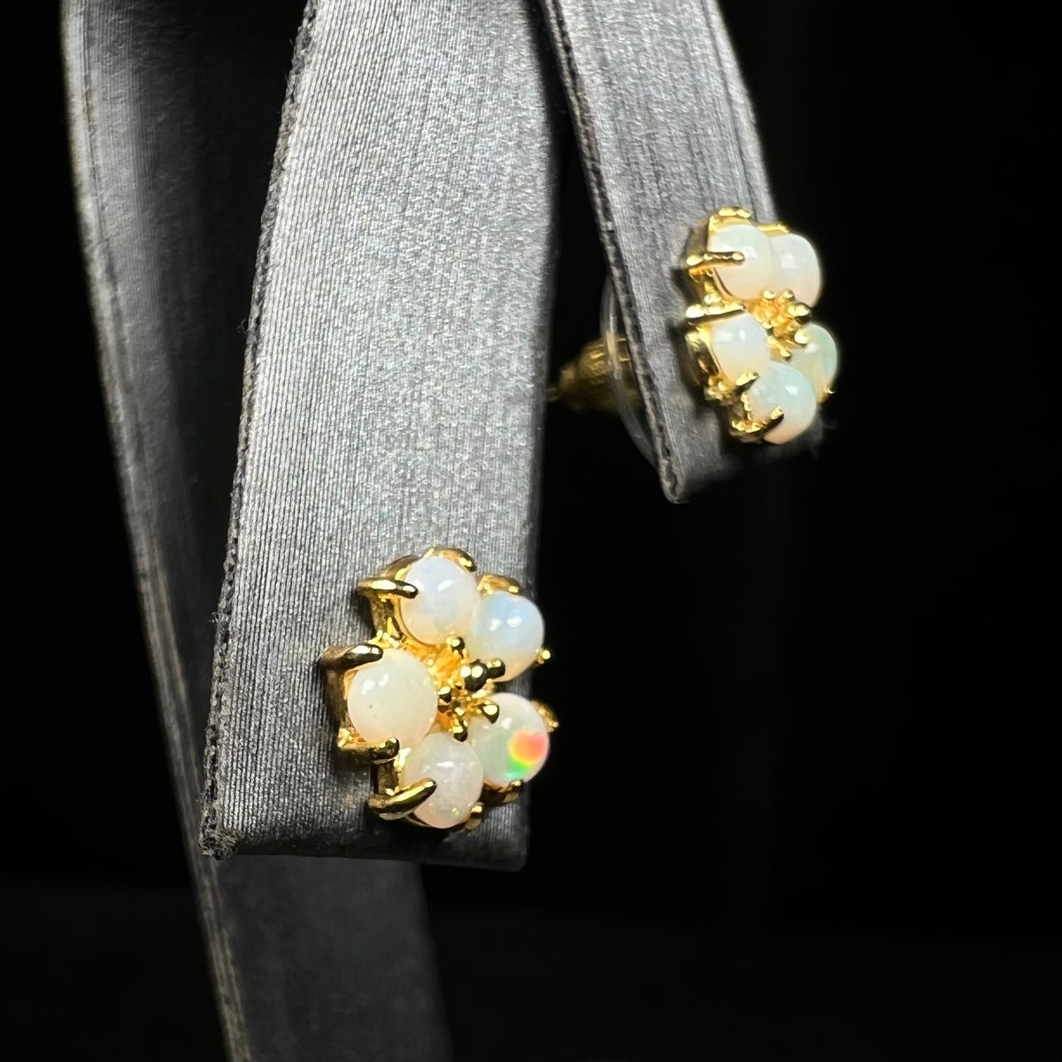 Pair of flower earrings formed by cluster of natural opals as the petals on earring display