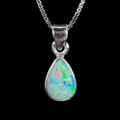 A dainty, sterling silver necklace bezel set with a natural, pear shaped opal stone.