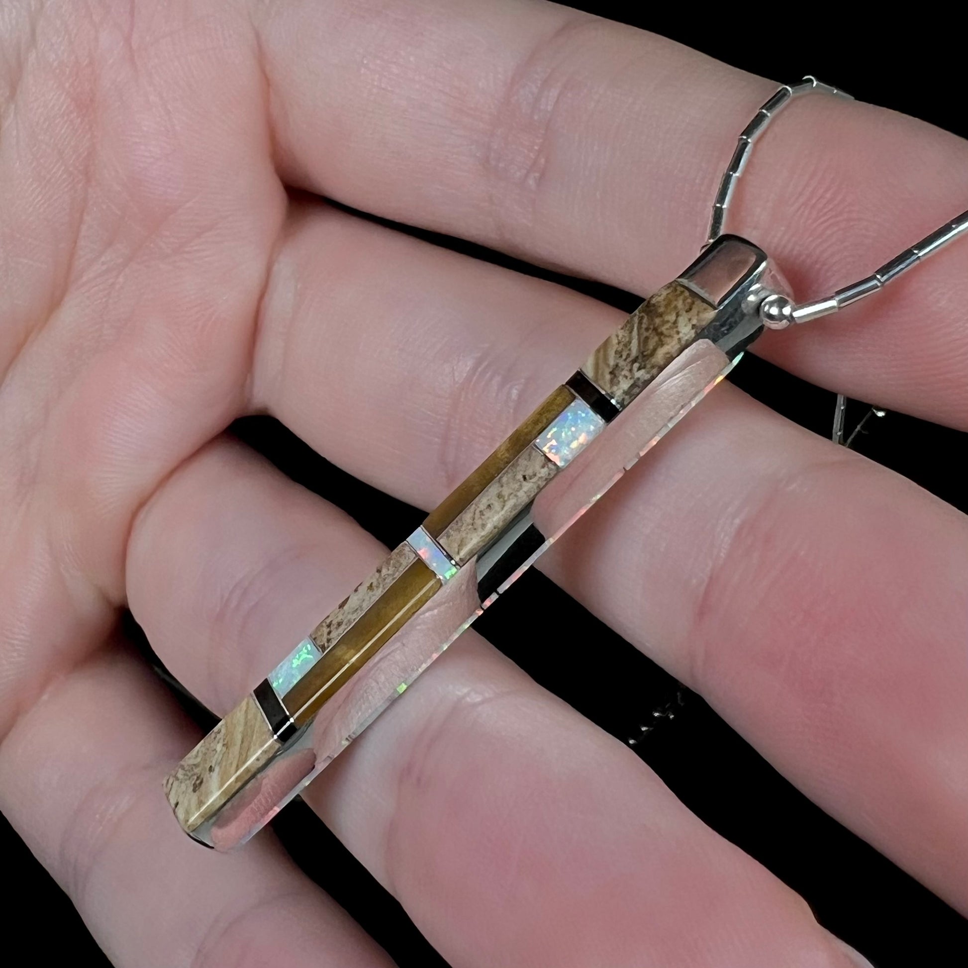 A side view of the Navajo inlay pendant, showing the jasper inlay side.