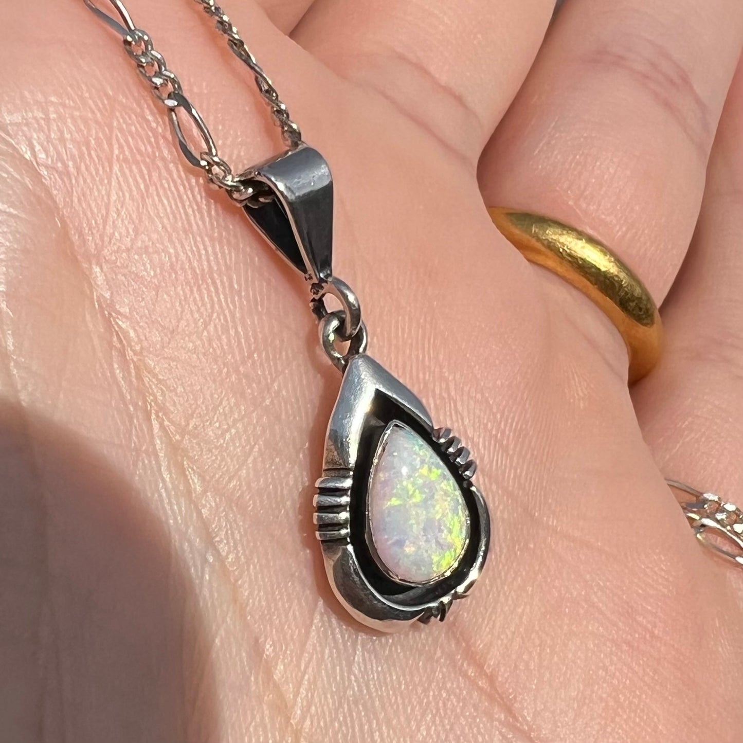 A pear shaped sterling silver Navajo pendant set with a green Australian opal made by artist, Chris Charley.
