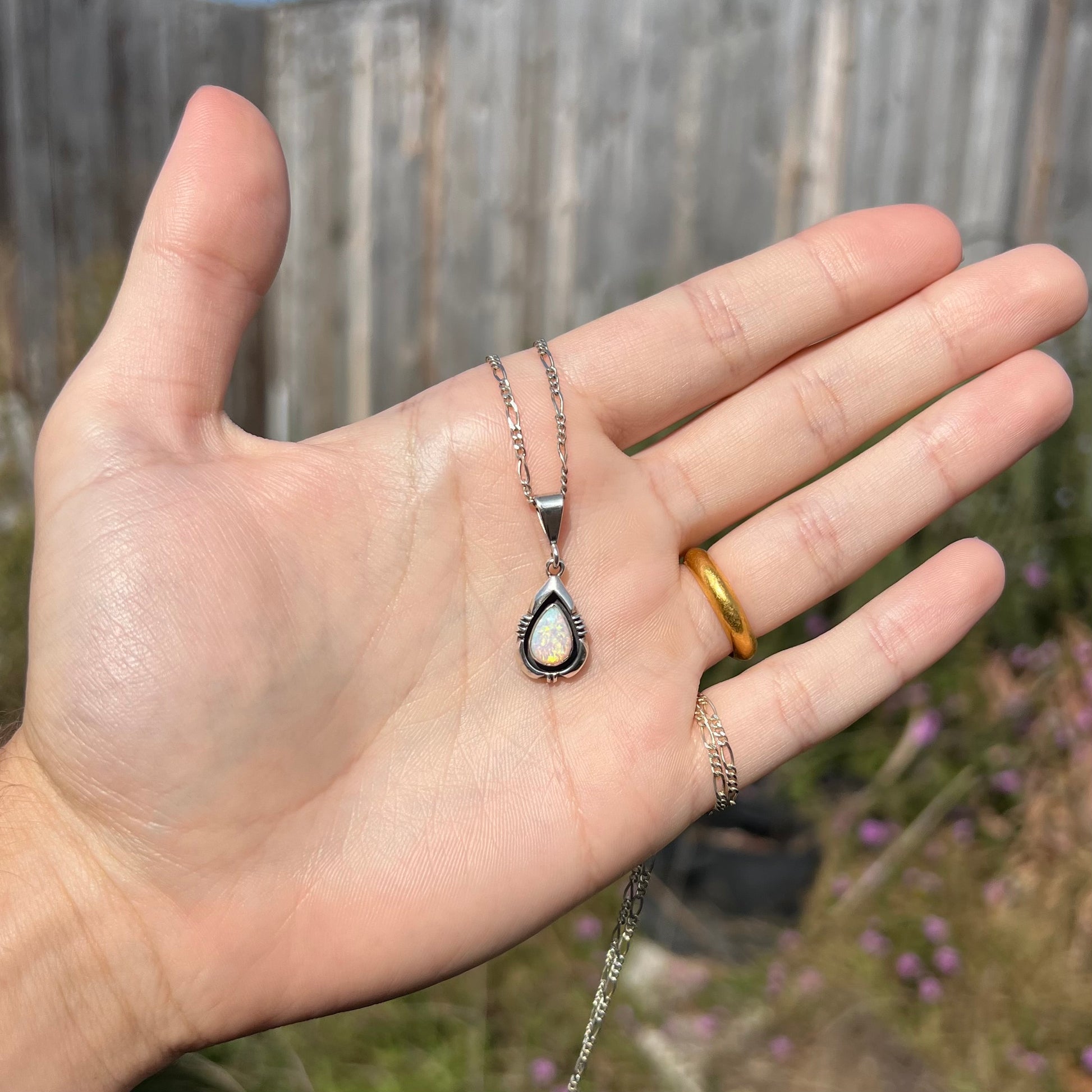 A pear shaped sterling silver Navajo pendant set with a green Australian opal made by artist, Chris Charley.