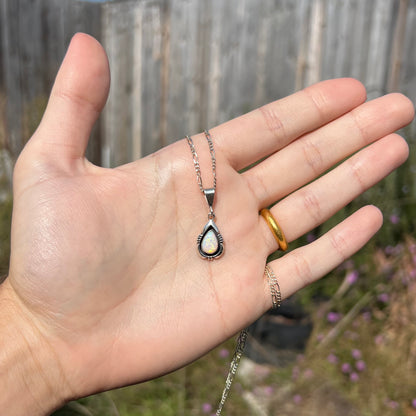A pear shaped sterling silver Navajo pendant set with a green Australian opal made by artist, Chris Charley.