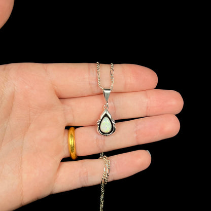 A pear shaped sterling silver Navajo pendant set with a green Australian opal made by artist, Chris Charley.