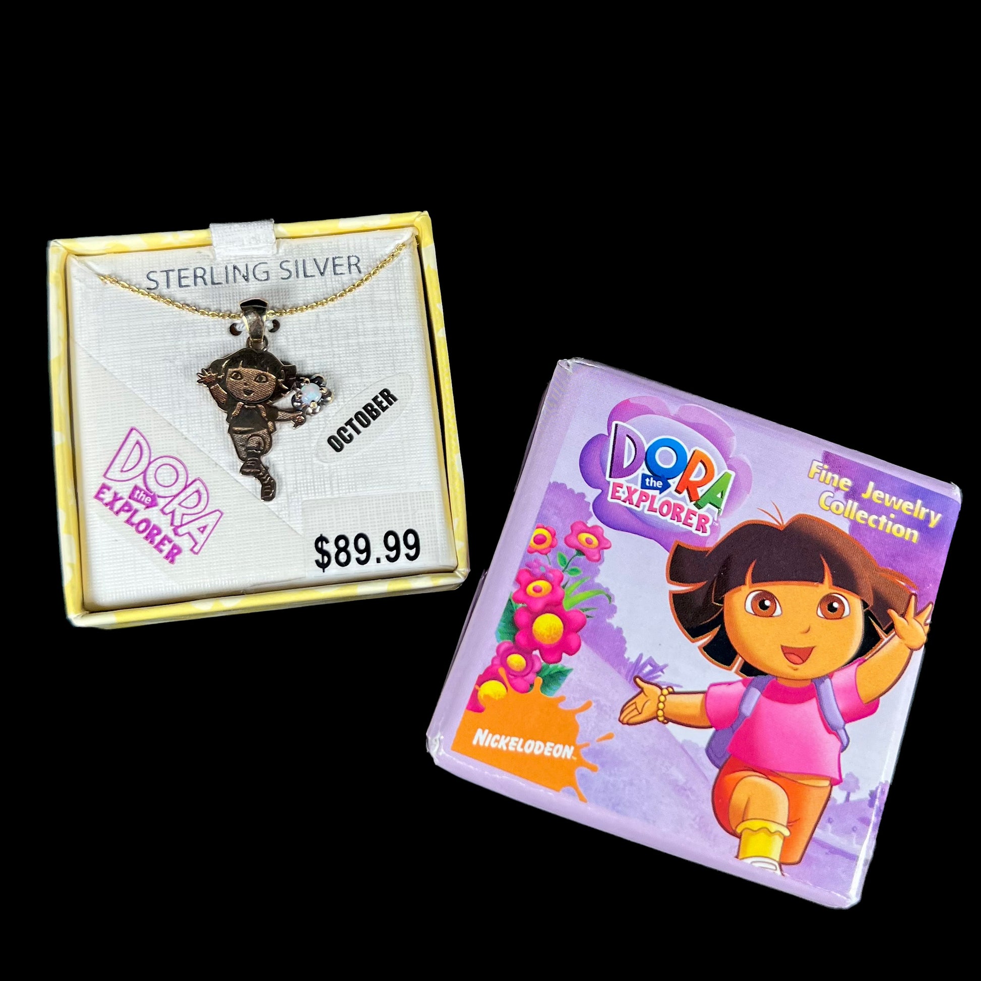 Dora the Explorer Fine Jewelry Collection gold-plated sterling silver opal necklace in Nickelodeon box on back background.