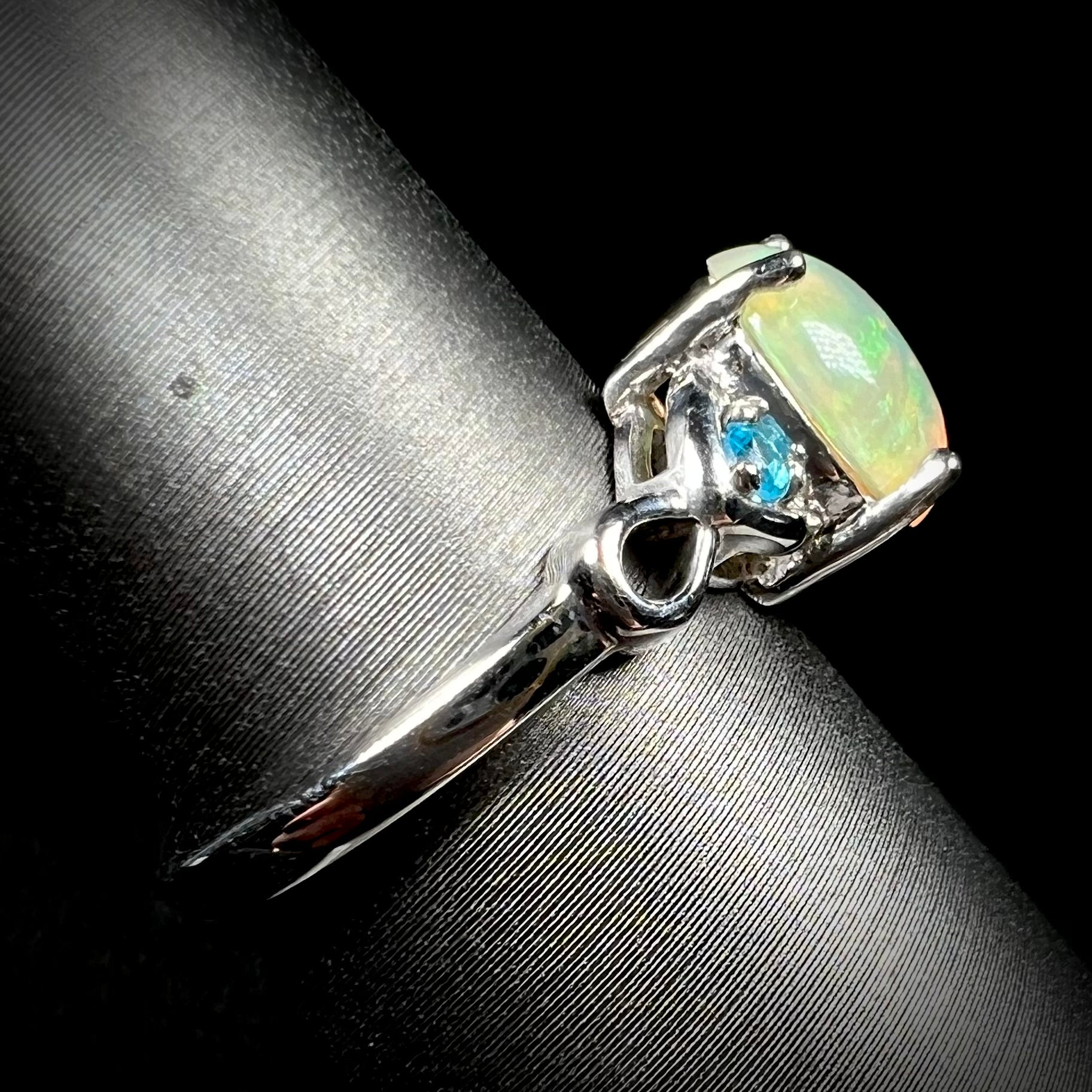 Side view of opal and blue apatite ring in sterling silver on ring display