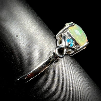 Side view of opal and blue apatite ring in sterling silver on ring display