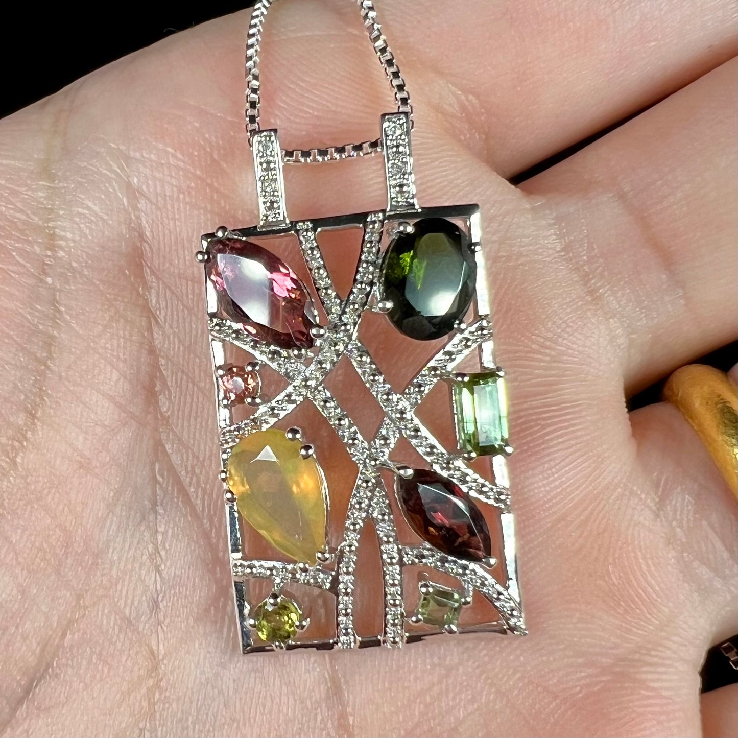 A sterling silver multi-gemstone necklace set with Ethiopian opal, tourmaline, and diamonds.