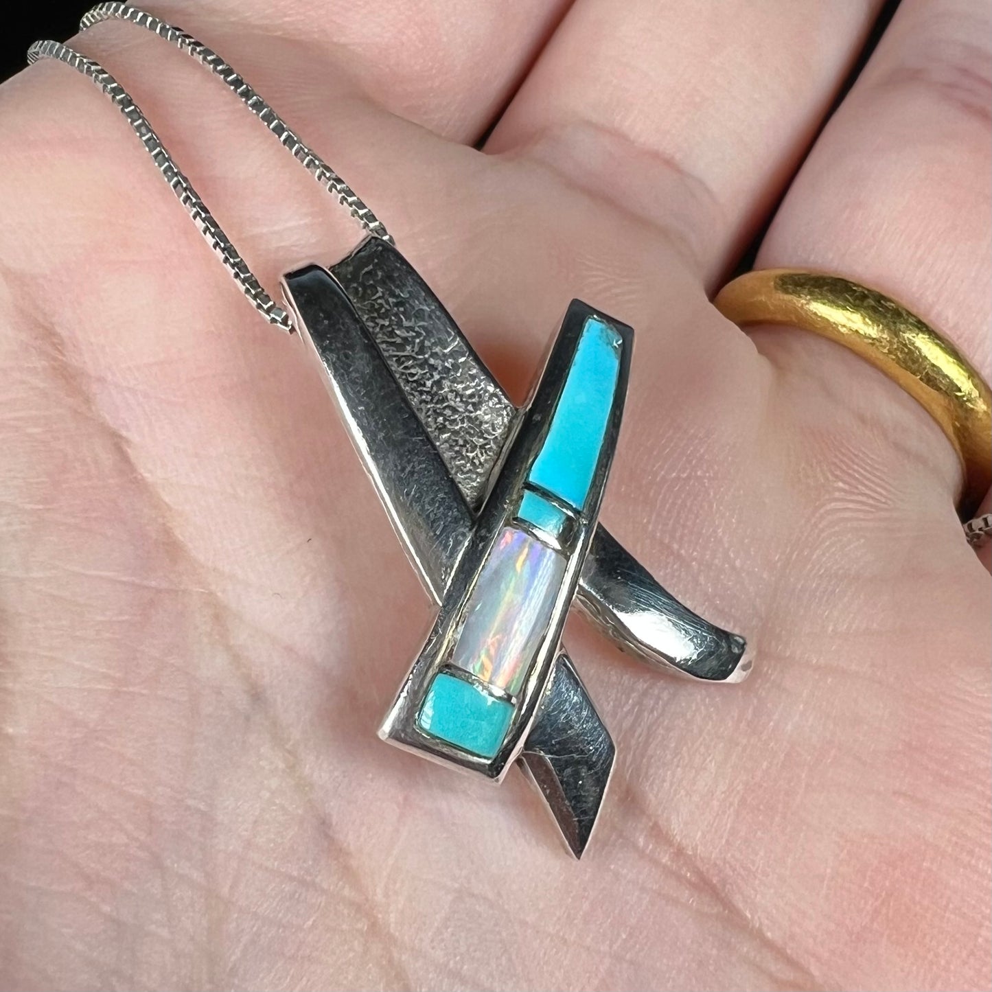 A folded design sterling silver turquoise and lab-created opal inlay necklace.