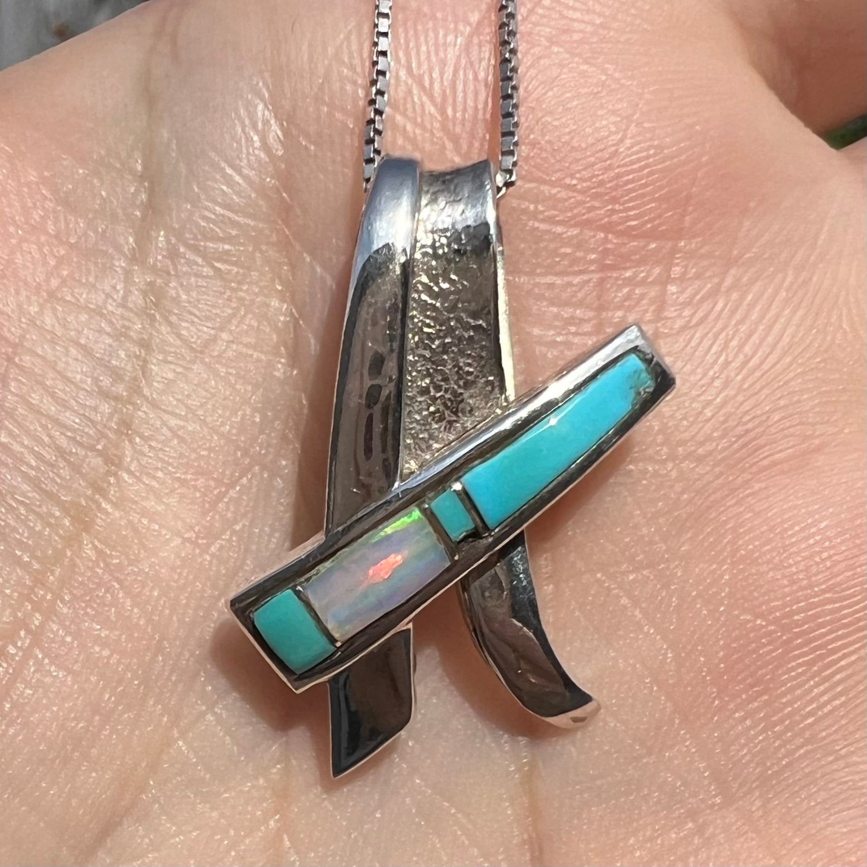 A folded design sterling silver turquoise and lab-created opal inlay necklace.