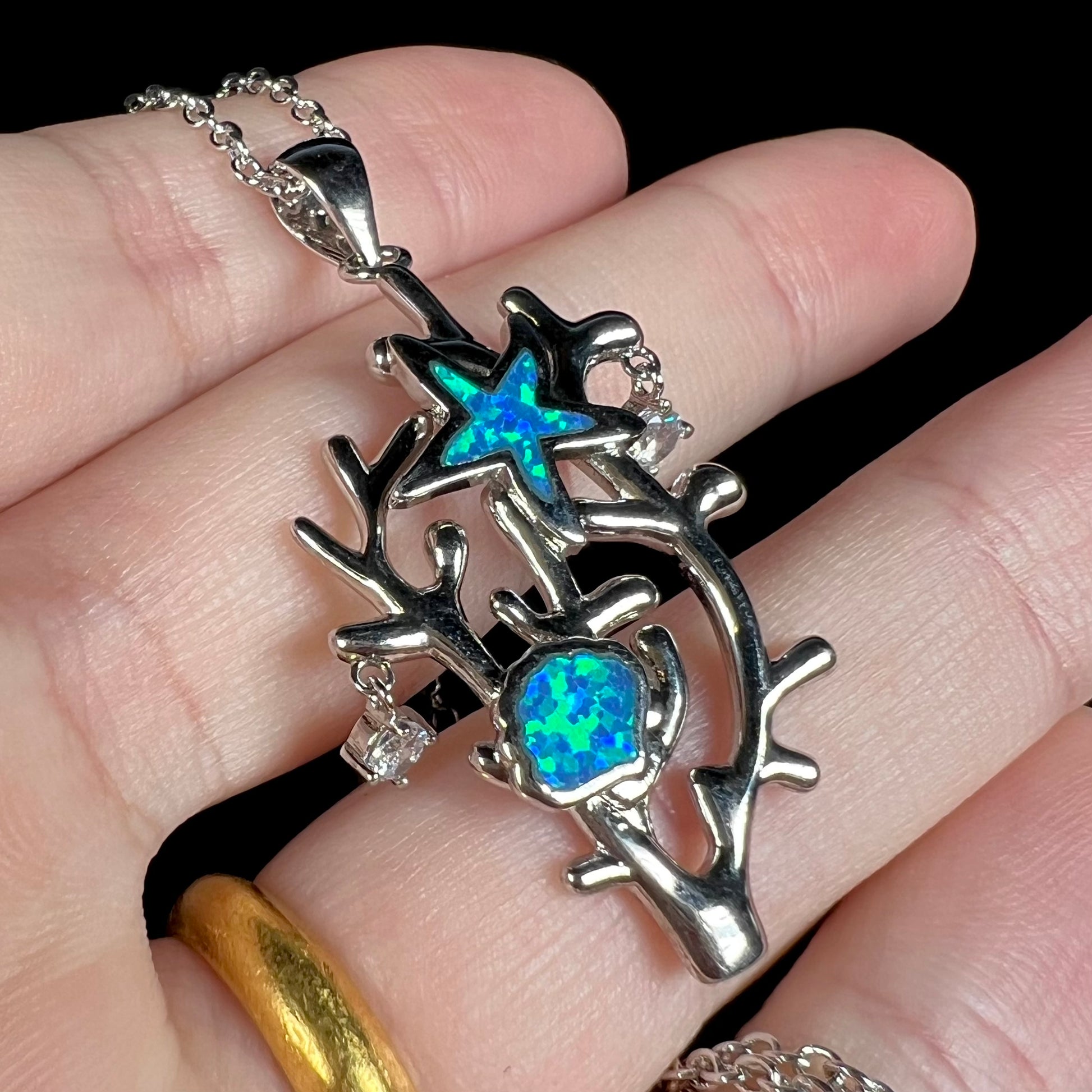 A silver plated coral reef necklace with blue lab-created opal inlay and CZ accents.