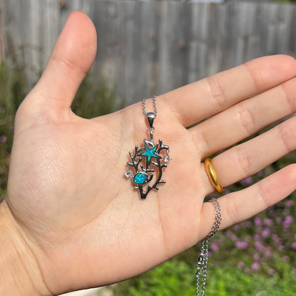 A silver plated coral reef necklace with blue lab-created opal inlay and CZ accents.