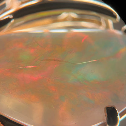 Crazing seen in a backlit Australian opal under a microscope.  Multiple cracks run into one another beneath the opal's surface.