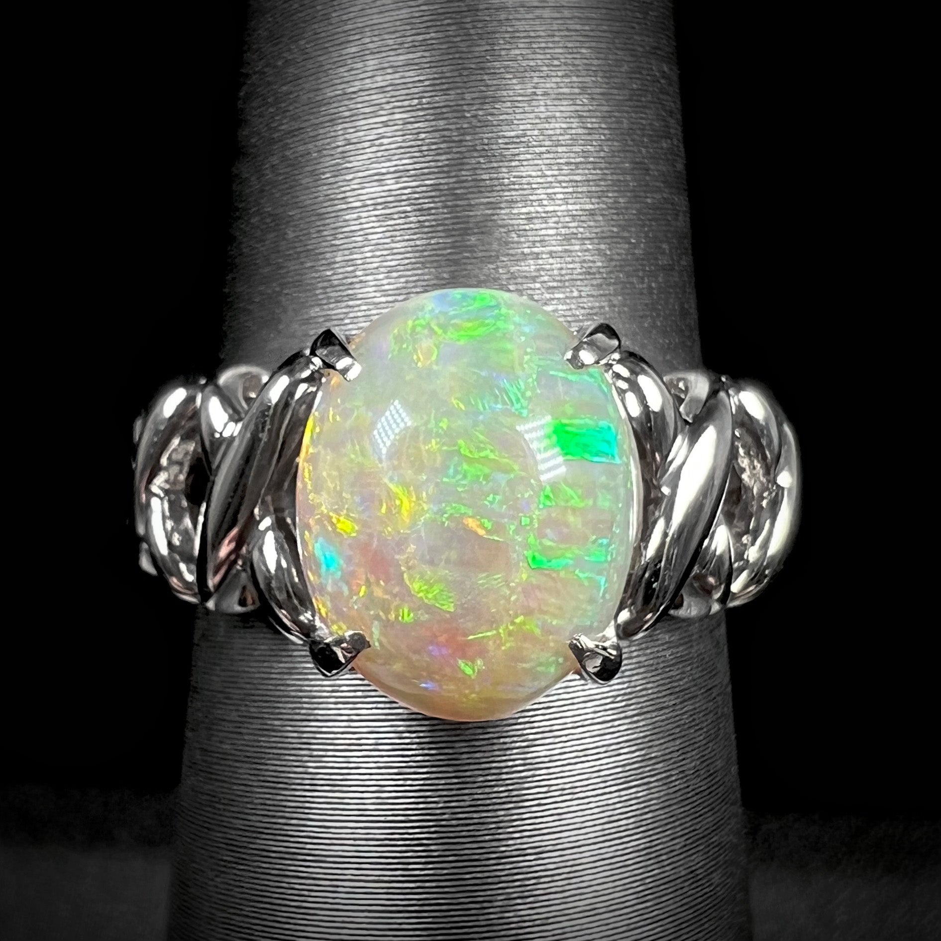 A platinum opal ring with an open crisscross-design band.