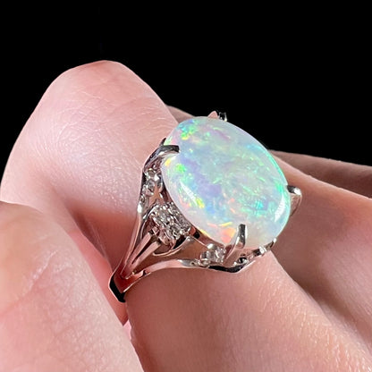 A platinum engagement ring set with a 4.83ct opal and diamond accents.