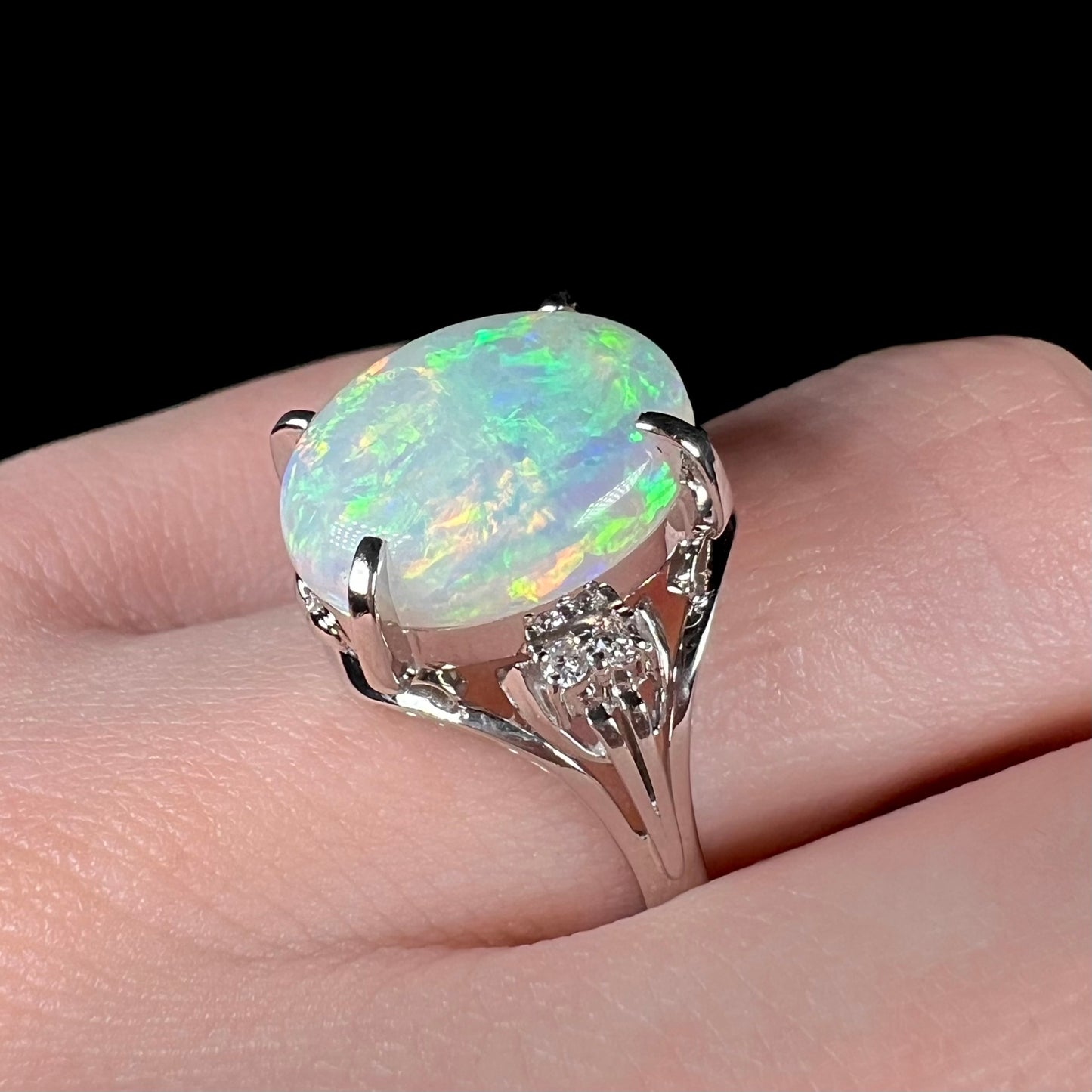 A platinum engagement ring set with a 4.83ct opal and diamond accents.