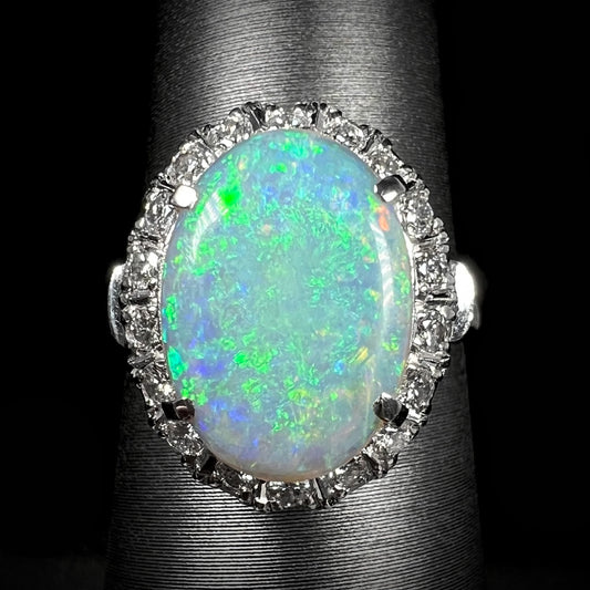 A vintage platinum engagement ring featuring a Mintabie semi-crystal opal with a diamond halo.