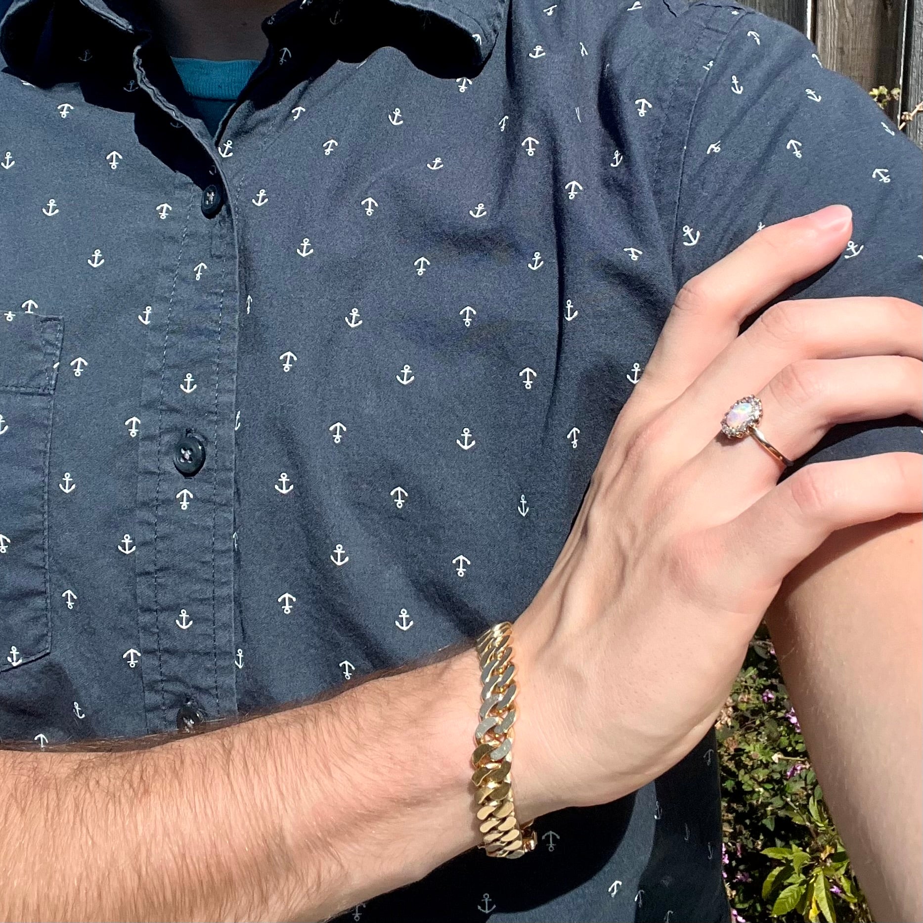 An Edwardian era opal engagement ring being modeled on a hand.