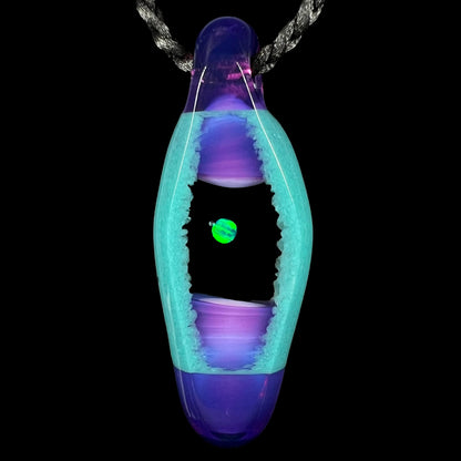A unisex lab-created opal and boro glass pendant by artist, Nathan Snyder, from his 'Opal Geode' pendant line, shown against a black background.