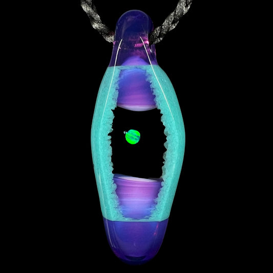 A unisex lab-created opal and boro glass pendant by artist, Nathan Snyder, from his 'Opal Geode' pendant line, shown against a black background.