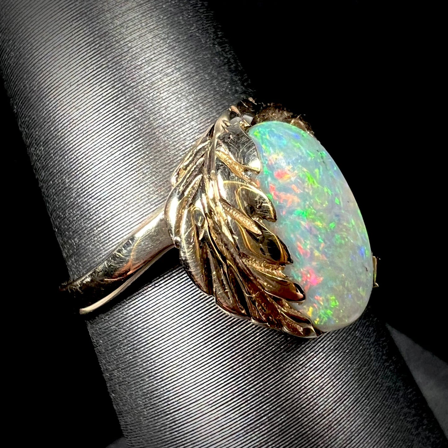 A Coober Pedy opal set into a yellow gold leaf and vine-design ring.