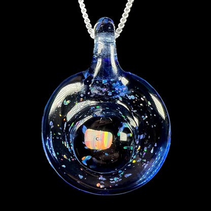 A lab-created opal in blue glass pendant by Michigan artist, Cameron Scott, shown close-up on a silver chain against black background.
